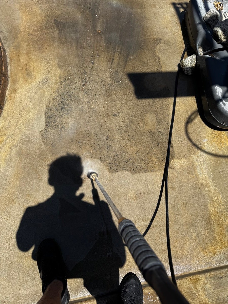 Overhead view of a concrete driveway being pressure washed in Lake Elsinore